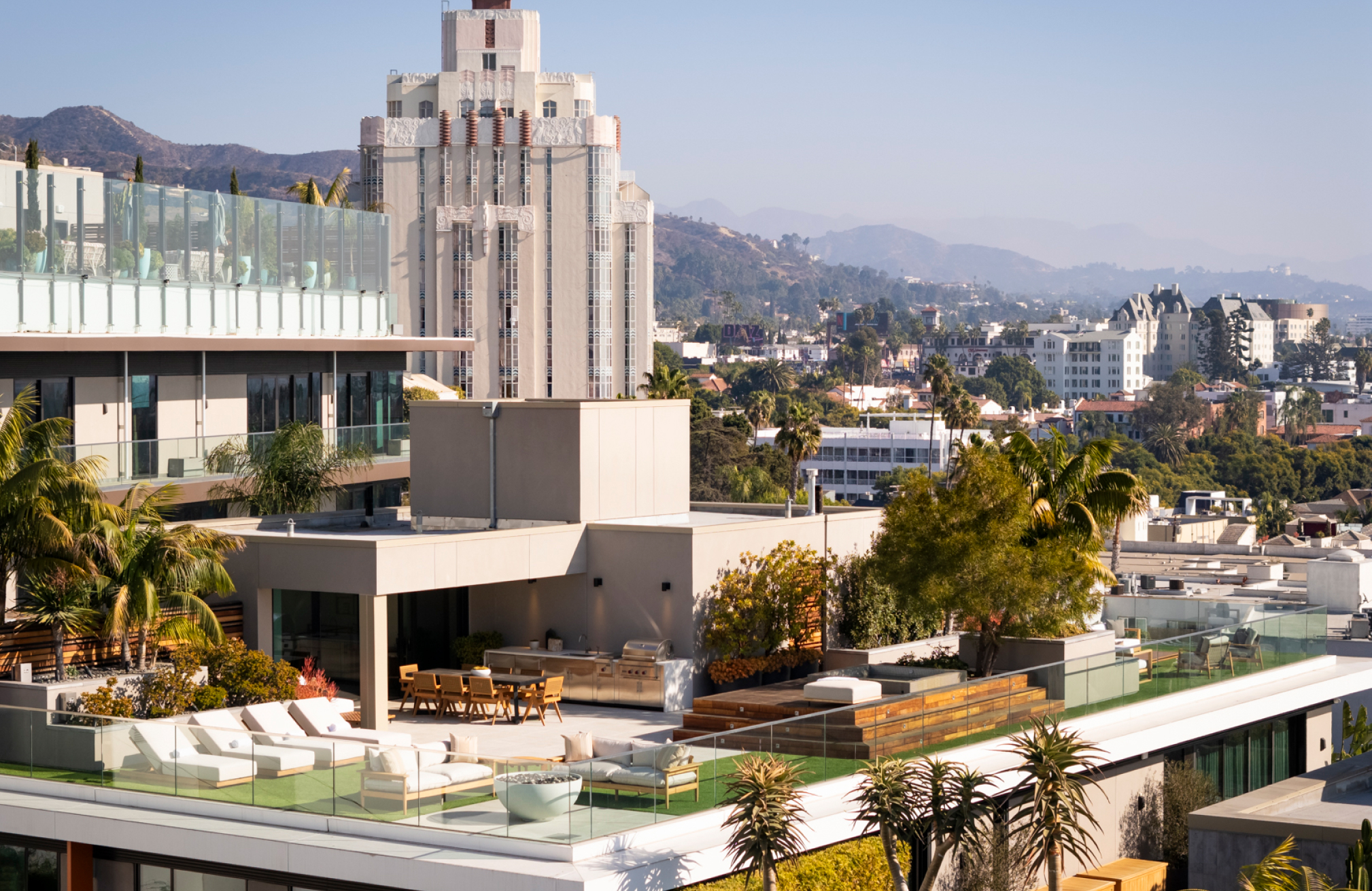 Urban cityscape with modern buildings and hillside views under clear blue sky